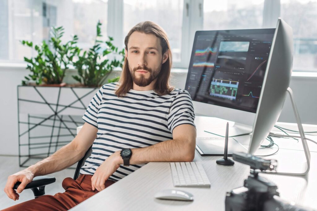 selective focus of handsome bearded editor sitting xd2ntyh